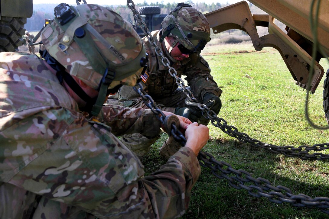 Soldiers secure tow chains while participating in vehicle recovery training during Exercise Saber Junction 16 at Hohenfels, Germany, April 5, 2016. Army photo by Pfc. Randy Wren