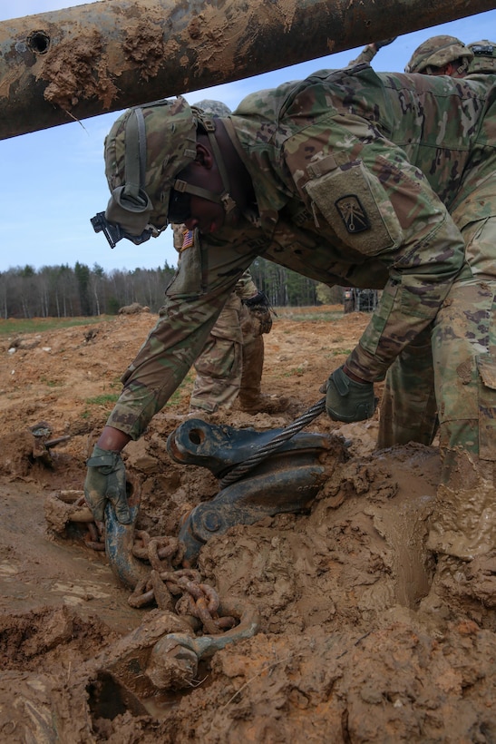 A soldier disconnects tow chains from a pulley system while participating in vehicle recovery training during Exercise Saber Junction 16 at Hohenfels, Germany, April 5, 2016. Army photo by Pfc. Randy Wren