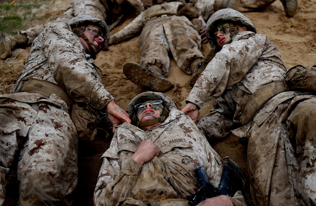 Combat Training: U.S. Marine Corps recruits drag a fellow recruit through an obstacle during the Crucible at the Marine Corps Recruit Depot, Parris Island, S.C., Dec. 3, 2015. The Crucible is the final test in recruit training, and represents the culmination of all the skills and knowledge a Marine should possess. U.S. Air Force photo by Staff Sgt. Kenneth Norman