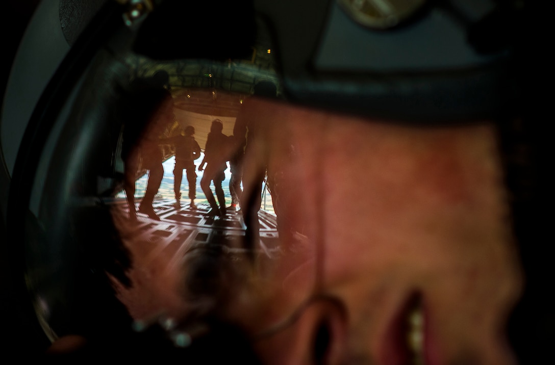 Combat Training: Airman 1st Class Lane Plummer photographs paratroopers from multiple allied nations as they exit a C-130J Super Hercules during International Jump Week at Ramstein Air Base, Germany, July 9, 2015. The five-day event was led by the 435th Contingency Response Group and provided multiple nations the opportunity to work side-by-side, increasing interoperability and strengthening relationships. Paratroopers traveled from throughout Europe and as far away as New Zealand to build stronger partnerships by jumping out of aircraft assigned to the 37th Airlift Squadron at Ramstein. Plummer is a photojournalist assigned to the 86th Airlift Wing Public Affairs. U.S. Air Force photo taken by Senior Airman Damon Kasberg