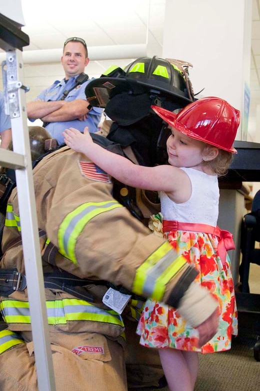 Lily, 3, attends a unique firefighter edition of story time.  Lily is the military child of an active duty Marine serving at The Basic School.