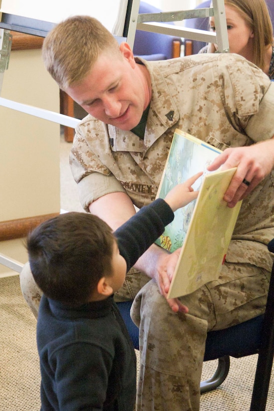 A Marine from Security Battalion reads to children. The special story time featured first responders such as paramedics, firefighters and military police.