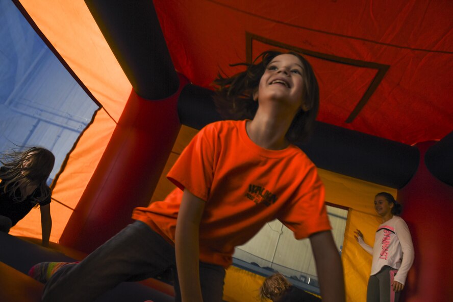 Children play in a bouncing house during the 2016 Spring Fling event April 16, 2016, at Creech Air Force Base, Nevada. This event helped bring comradery and raised moral amongst Creech members and their families. (U.S. Air Force photo by Senior Airman Adarius Petty/Released)