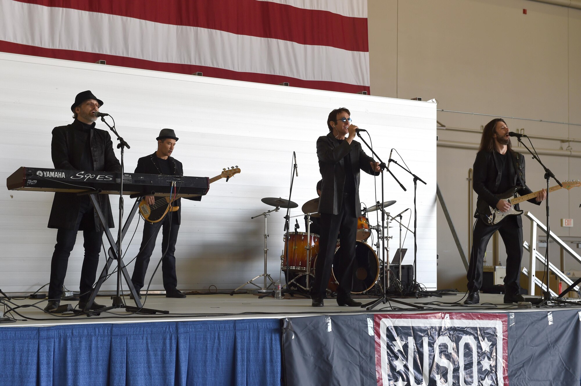 A Tribute bands to the Bee Gees perform for Creech Airman and their families during the 2016 Spring Fling Event April 16, 2016, at Creech Air Force Base, Nevada.  This event was held to boost morale of Creech members and their families, which included games, food, and musical performances. (U.S. Air Force photo by Senior Airman Adarius Petty/Released)