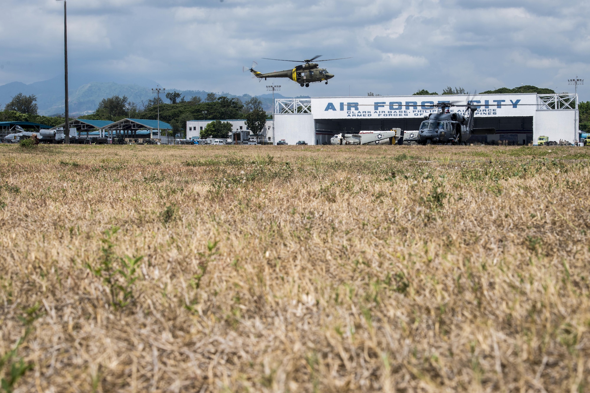 A Philippine Air Force PZL W-3 Sokół search and rescue helicopter flies over as two U.S. Air Force HH-60G Pave Hawk helicopters, with the 33rd Rescue Squadron, Kadena Air Base, Japan, prepare for lift off at Clark Air Base, Philippines, April 19, 2016. At Clark AB, the two country’s air and ground forces maintain a close bilateral bond through annual military exercises. The HH-60Gs are part of the first Air Contingent stood up here by U.S. Pacific Command in order to promote interoperability with the Philippine Air Force, build upon our already strong relationship, and reaffirm our commitment to the Indo-Asia-Pacific region. (U.S. Air Force photo by Staff Sgt. Benjamin W. Stratton)