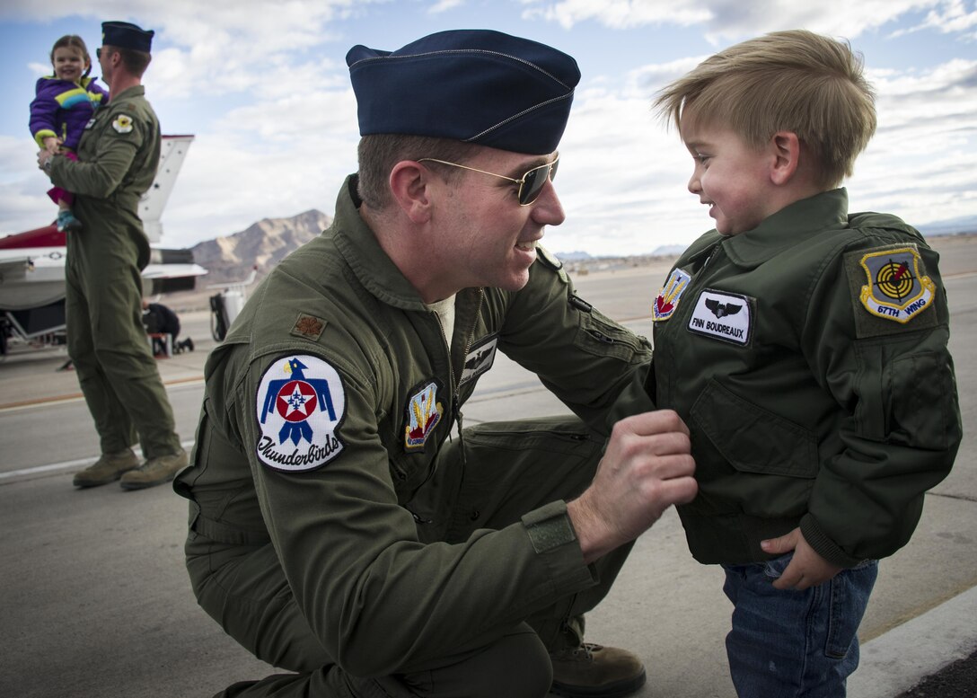 Features: Maj. Joshua Boudreaux, Thunderbird 2, and Maj. Jason Curtis, Thunderbird 5, are greeted by their children after performing their first Delta Formation sortie, Nellis Air Force Base, Nev., Jan. 13, 2015. U.S. Air Force photo by Tech Sgt. Manuel J. Martinez
