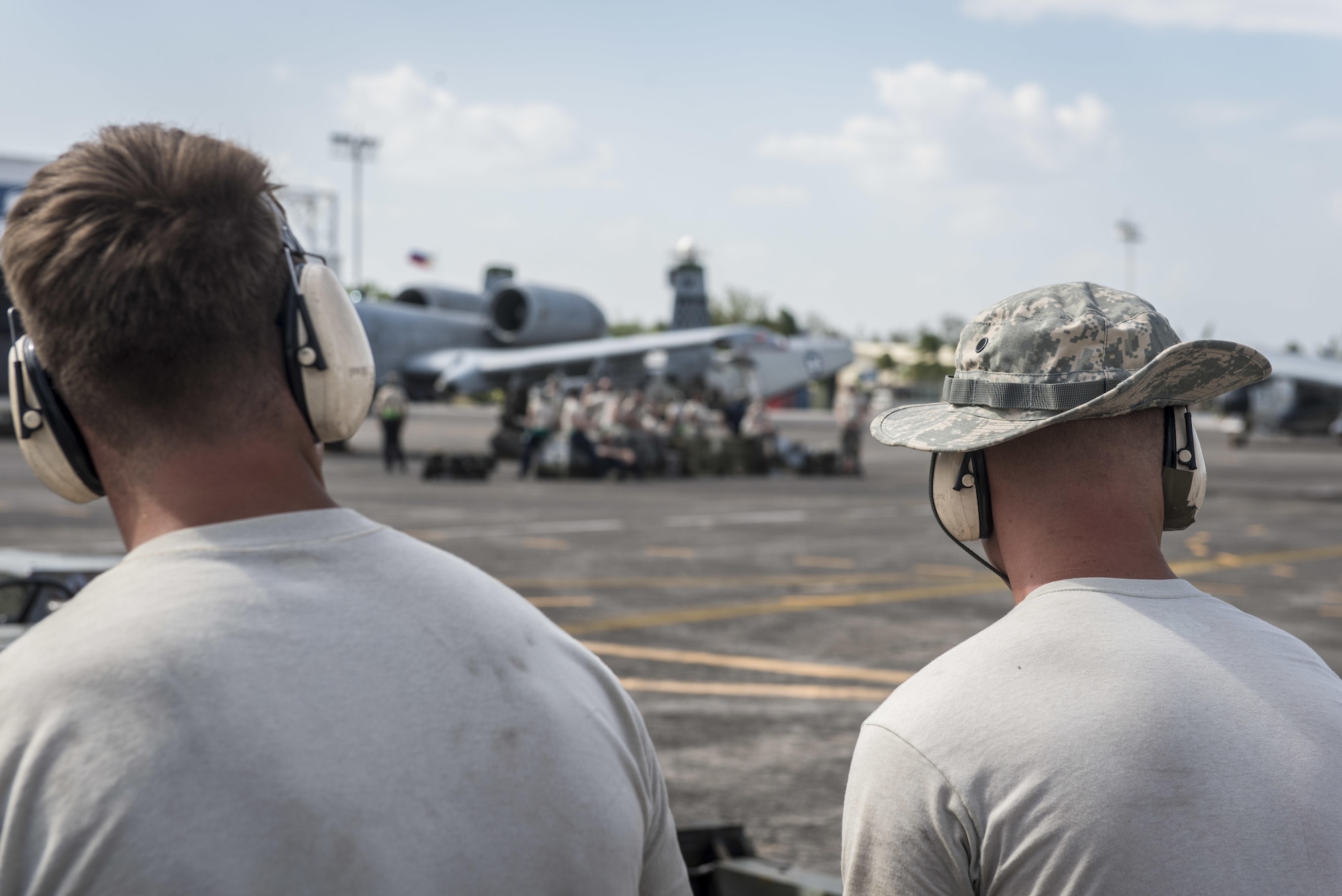 Two U.S. Air Force maintenance Airmen, with the 51st Fighter Wing, Osan Air Base, Republic of Korea, take a break after successfully launching two A-10C Thunderbolt IIs at Clark Air Base, Philippines, April 19, 2016. Maintenance Airmen play a critical role in the newly stood up Air Contingent’s ongoing operations ranging from air and maritime domain awareness, personnel recovery, combating piracy, and assurance all nations have access to the regional air and maritime domains in accordance with international law. The A-10C is capable of loitering close to the surface for extended periods to allow for excellent visibility over land and sea domains and can be serviced and operated from austere bases with limited facilities. (U.S. Air Force photo by Staff Sgt. Benjamin W. Stratton)