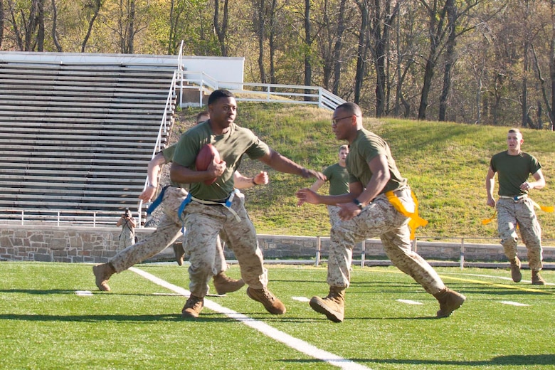 Marines team up in a game of flag football.