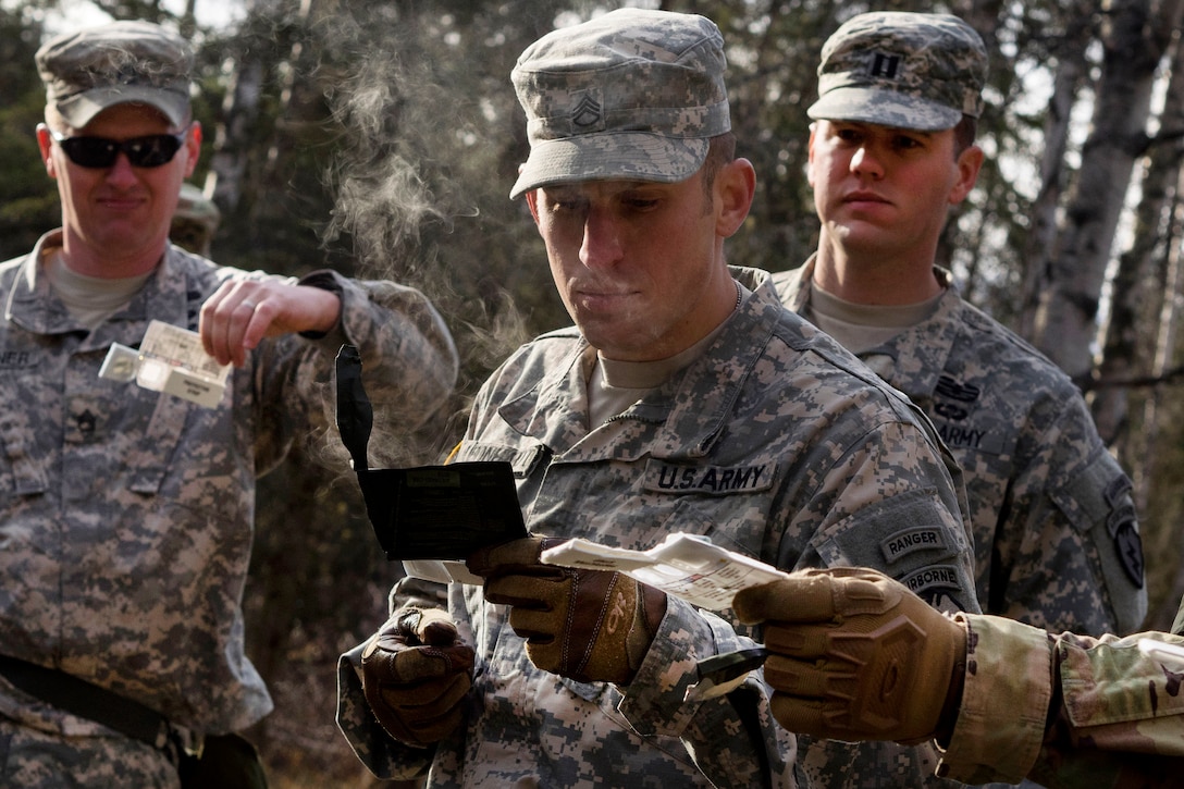 Army Staff Sgt. Derek Leonhardt, center, conducts chemical, biological, radiological and nuclear defense training at Joint Base Elmendorf-Richardson, Alaska, April 13, 2016. Leonhardt is assigned to the 25th Infantry Division, 40th Cavalry Regiment, 4th Brigade Combat Team (Airborne), Alaska. Air Force photo by Justin Connaher