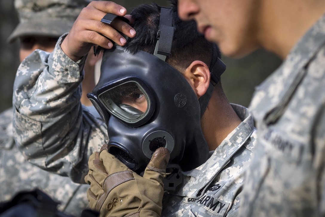 A paratrooper dawns his protective mask before participating in chemical, biological, radiological and nuclear defense training at Joint Base Elmendorf-Richardson, Alaska, April 13, 2016. Air Force photo by Justin Connaher