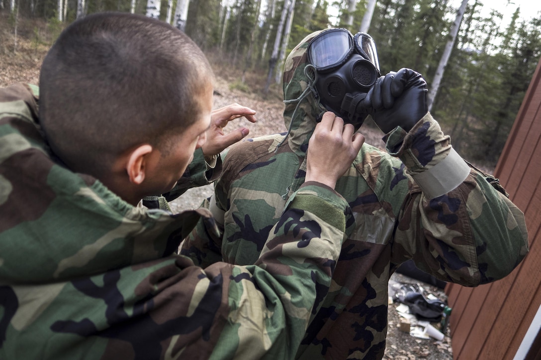 Soldiers check their protective masks before participating in chemical, biological, radiological and nuclear defense training at Joint Base Elmendorf-Richardson, Alaska, April 13, 2016. Air Force photo by Justin Connaher