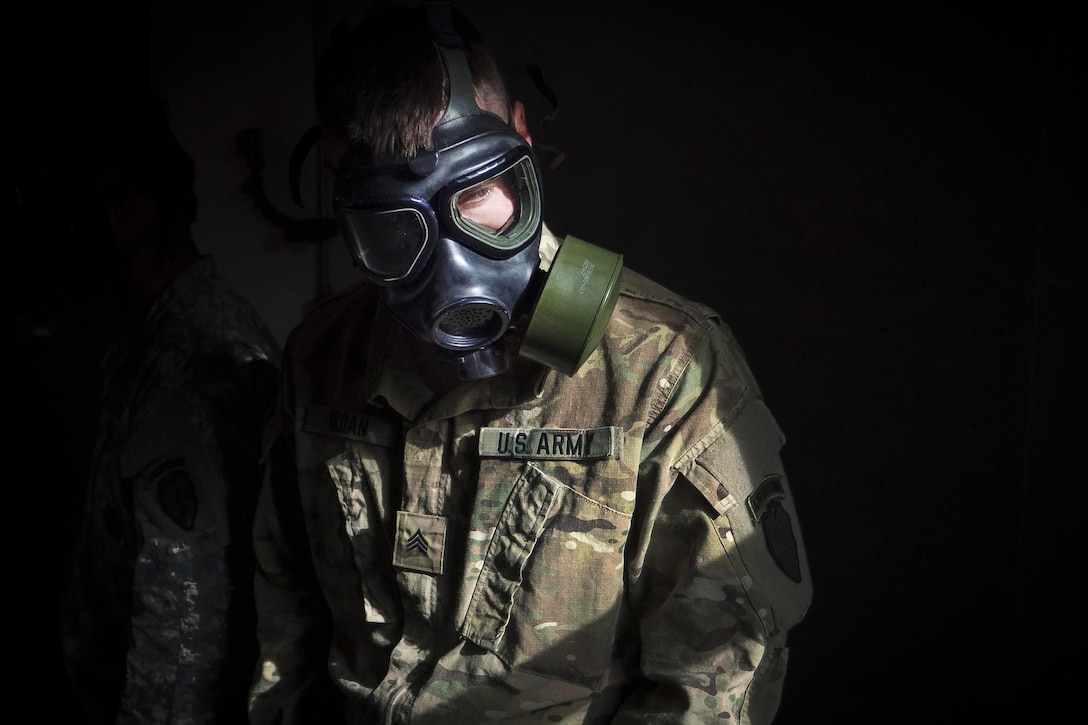 Army Sgt. Anthony Sloan waits for the order to remove his protective mask and expose himself to tear gas during chemical, biological, radiological and nuclear defense training at Joint Base Elmendorf-Richardson, Alaska, April 13, 2016. Sloan is assigned to the 25th Infantry Division, 40th Cavalry Regiment, 4th Brigade Combat Team (Airborne). Air Force photo by Justin Connaher