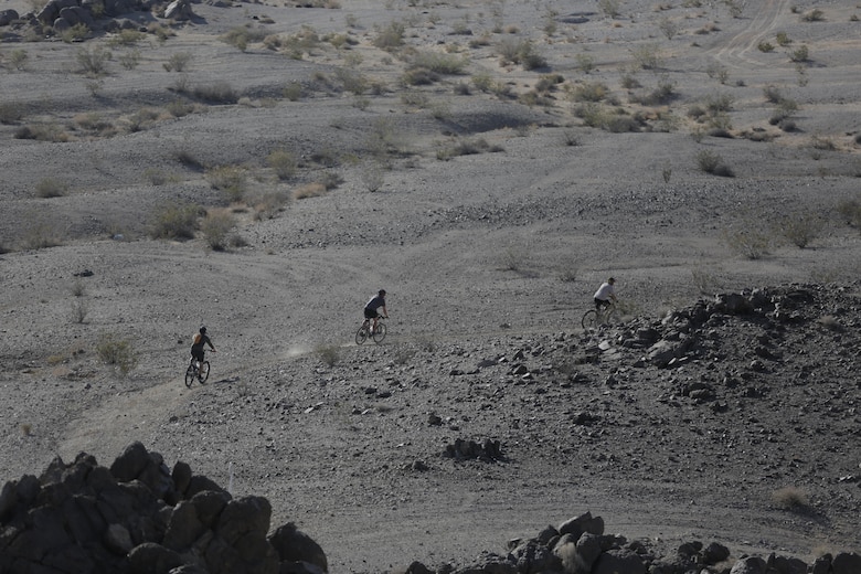 Riders follow the winding dirt paths during the Annual Earth Day Mountain Bike Ride held near Range 100 aboard the Combat Center April 13, 2016. The eight-mile ride started at Range 100 and took participants through designated trails behind the range. (Official Marine Corps photo by Pfc. Dave Flores/Released)