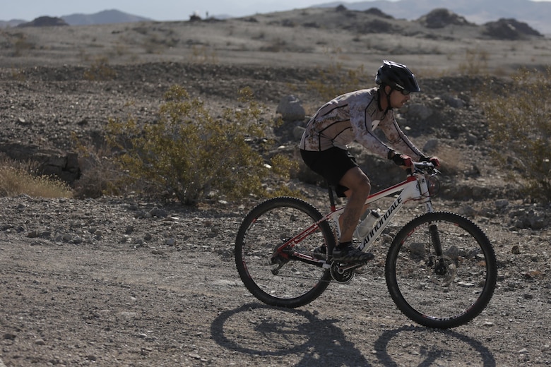 Jesse Santana, tank mechanic, Exercise Support Division, leads during the Annual Earth Day Mountain Bike Ride held near Range 100 aboard the Combat Center April 13, 2016. The eight-mile ride started at Range 100 took participants through designated trails behind the range. (Official Marine Corps photo by Pfc. Dave Flores/Released)
