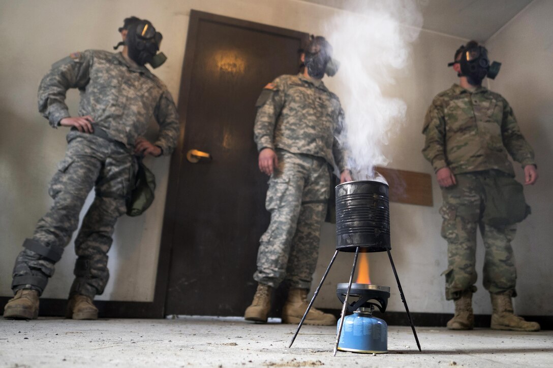 Soldiers wait for the order to remove their protective masks and expose themselves to tear gas during chemical, biological, radiological and nuclear defense training at Joint Base Elmendorf-Richardson, Alaska, April 13, 2016. Air Force photo by Justin Connaher