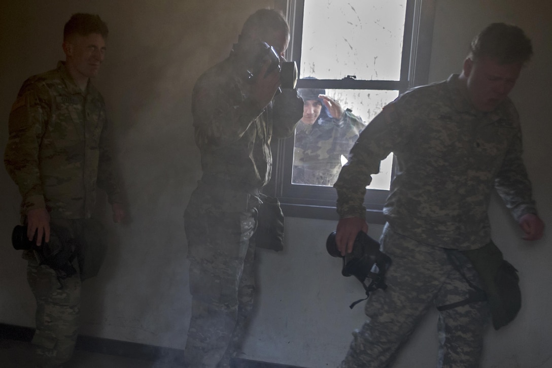 Soldiers react to tear gas exposure during chemical, biological, radiological and nuclear defense training at Joint Base Elmendorf-Richardson, Alaska, April 13, 2016. Air Force photo by Justin Connaher