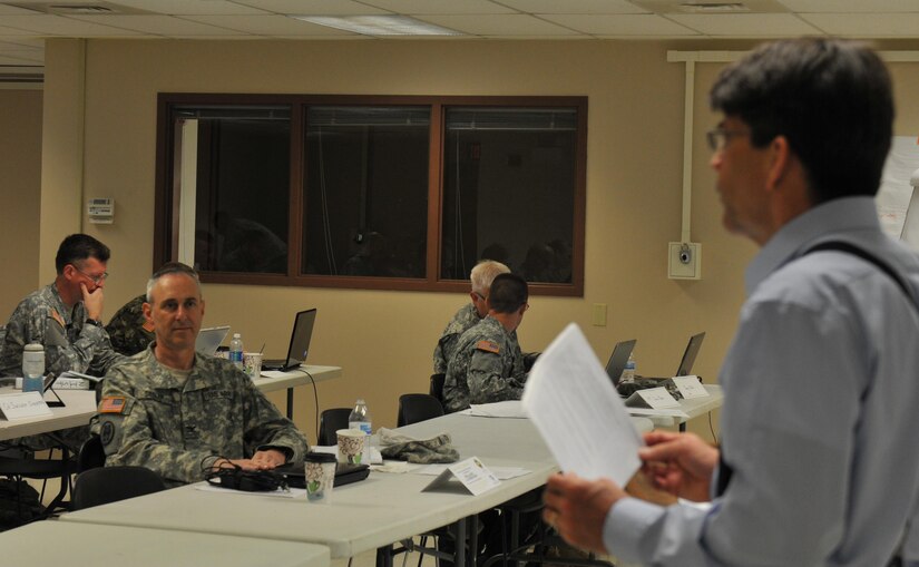 U.S. Army Reserve Col. Adam Siegler, the Staff Judge Advocate for the 335th Signal Command (Theater), East Point, Georgia, listens to the instructor at Cyber Shield 2016, as he discusses how legal factors into cyber security April 20, 2016 at Camp Atterbury, Ind. Cyber Shield 2016 is an Army National Guard cyber training exercise designed to develop and train cyber capable forces to include Army Reserve Soldiers, Marines, Air National Guardsmen and other federal agencies.