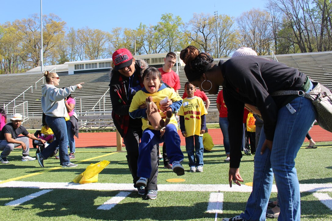 Angie enjoys completing a long jump during an event at the Special Olympics, hosted by EFMP aboard Marine Corps Base Quantico, Apr. 16.