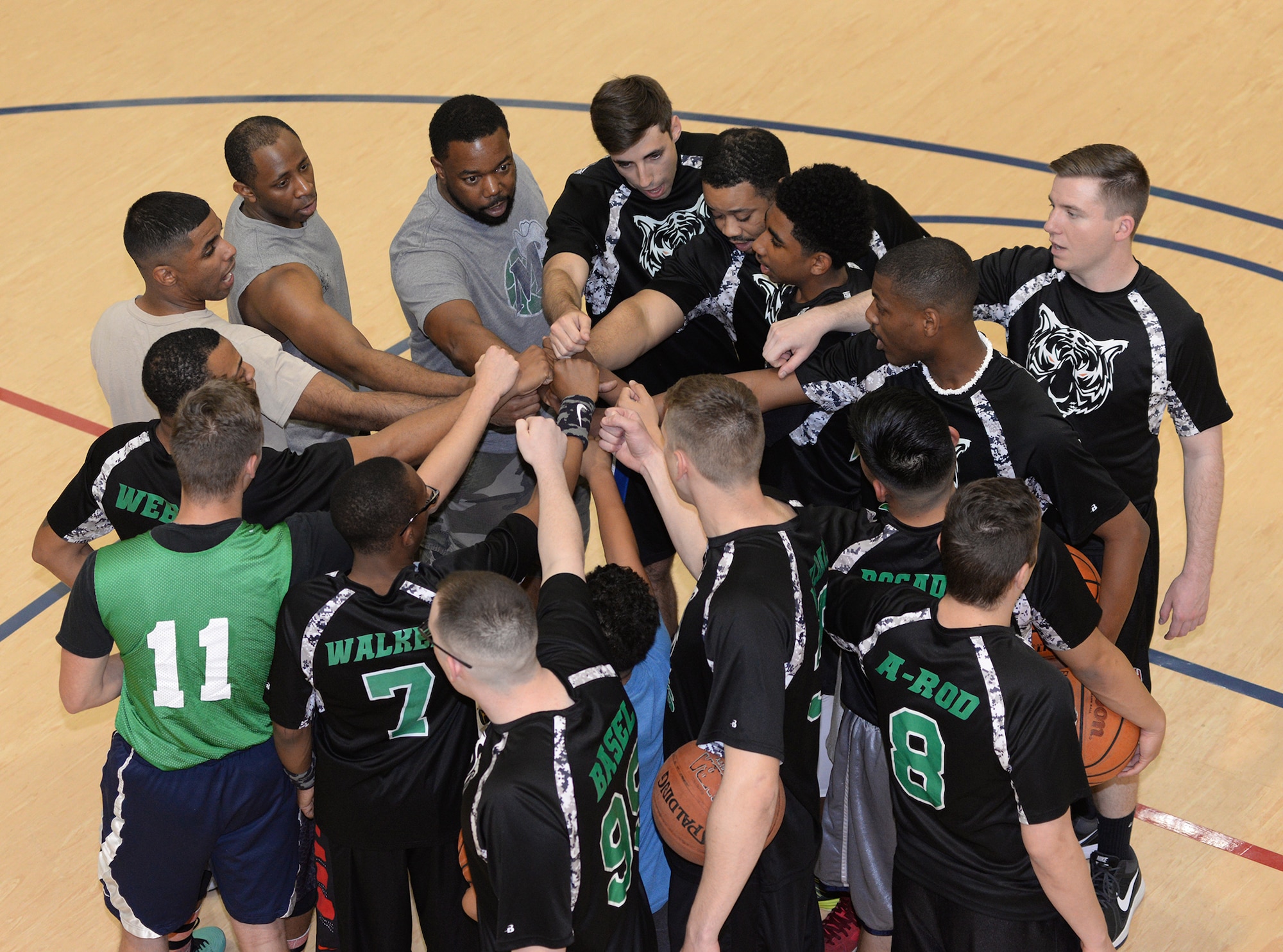 Team members from the 2nd Communications Squadron intramural basketball team huddle up prior to a game at Barksdale Air Force Base, La., April 14, 2016. The team completed the regular season with a 9-3 record and toppled an undefeated team and tournament favorite before eventually falling to the team from the 2nd Security Forces Squadron in the championship game. (U.S. Air Force photo/Airman 1st Class Curt Beach)