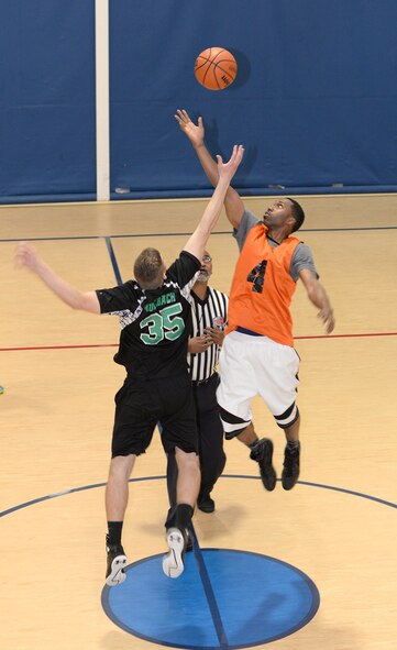 William Muhlbach, 2nd Communications Squadron center, and Josh Porter, 2nd Security Forces Squadron power forward, elevate for the opening tipoff of a championship basketball game at Barksdale Air Force base, La., April 14, 2016. The 2nd CS Tigers squared off against the 2nd SFS Bayou Warriors for the title of base intramural basketball champs. (U.S. Air Force photo/Airman 1st Class Curt Beach)