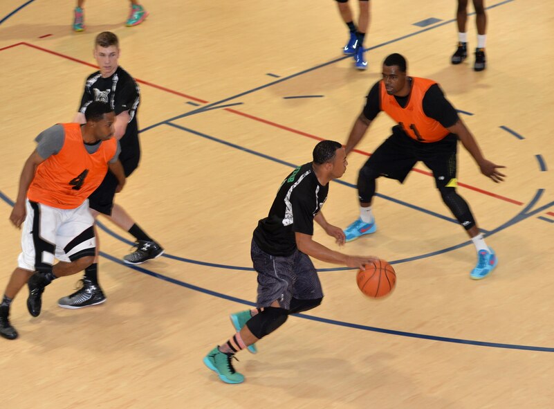 Exzavior Webb, 2nd Communcations Squadron shooting guard, looks for the open man, during a championship basketball game at Barksdale Air Force Base, La., April 14, 2016.  The 2nd CS team finished the regular season with a 9-3 record and knocked off an undefeated team and championship favorite on its way to the season’s final game. (U.S. Air Force photo/Airman 1st Class Curt Beach) 