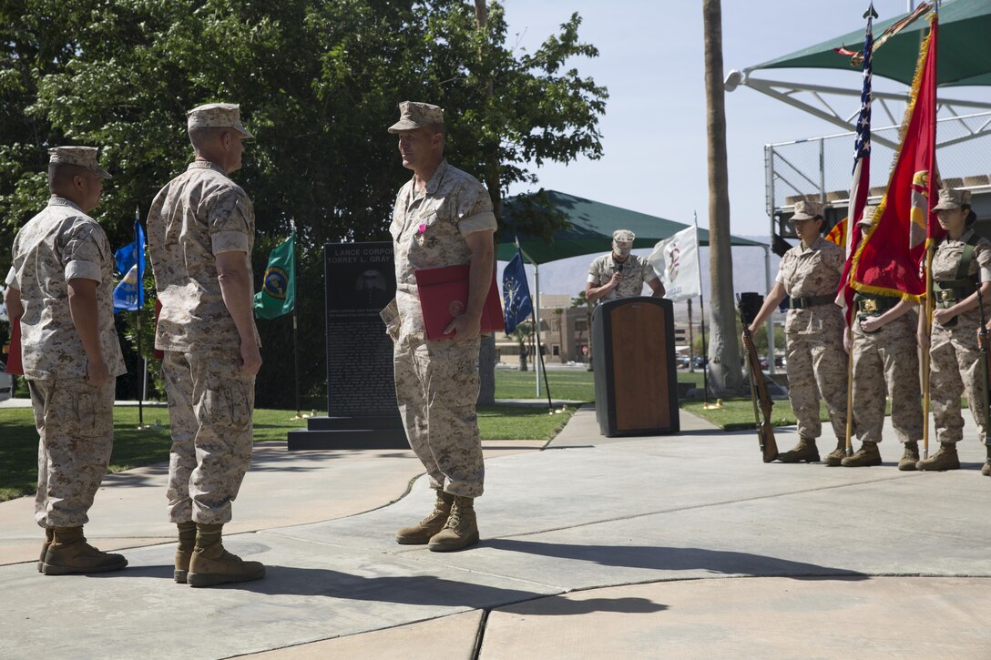 Maj. Gen. Lewis A. Craparotta, Combat Center Commanding General, awards Col. Andrew R. Kennedy, former director of Tactical Training and Exercise Control Group, the Legion of Merit during Kennedy’s retirement ceremony at Lance Cpl. Torrey L. Gray Field April 15, 2016. (Official Marine Corps photo by Cpl. Medina Ayala-Lo/Released)