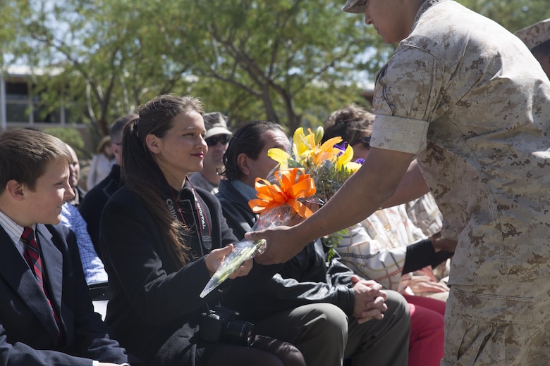 Katherine Kennedy, daughter of Col. Andrew R. Kennedy, former director of Tactical Training and Exercise Control Group, is presented flowers during her father’s retirement ceremony at Lance Cpl. Torrey L. Gray Field April 15, 2016. (Official Marine Corps photo by Cpl. Medina Ayala-Lo/Released)