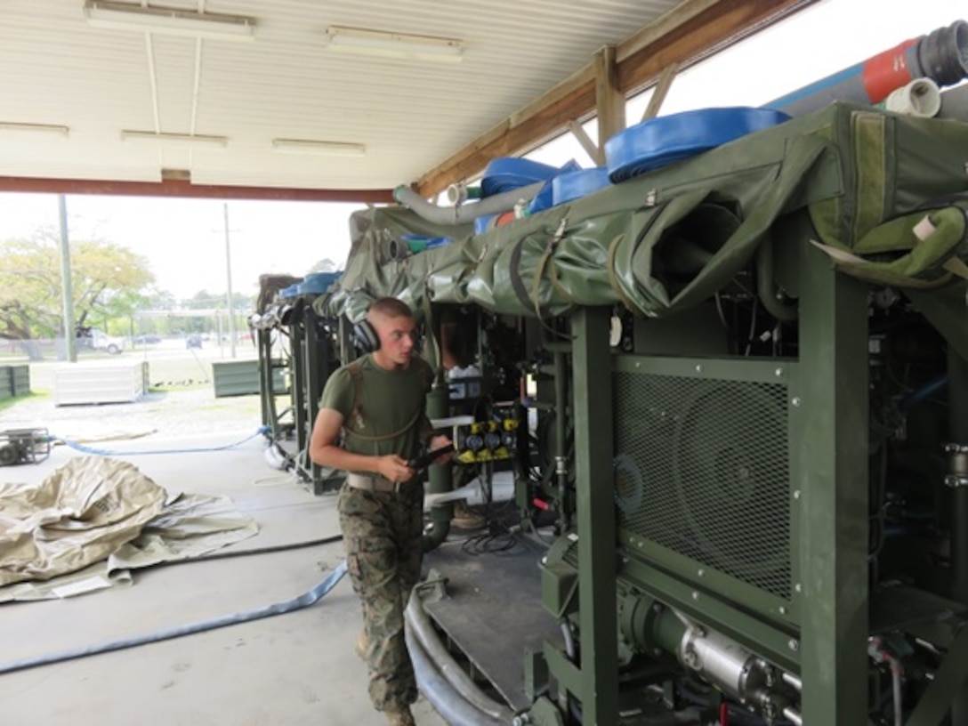 A Marine attached to the Basic Water Support Technician course 4-16 (BWST 4-16) aboard Marine Corps Engineer School, Camp Lejeune, N.C. familiarizes himself with the characteristics, capabilities, components, and instrumentation of the Tactical Water Purification System (TWPS). The Marine is using an iPad to display the Technical Manual while he identifies component locations and practices operating the TWPS on the actual piece of equipment.




