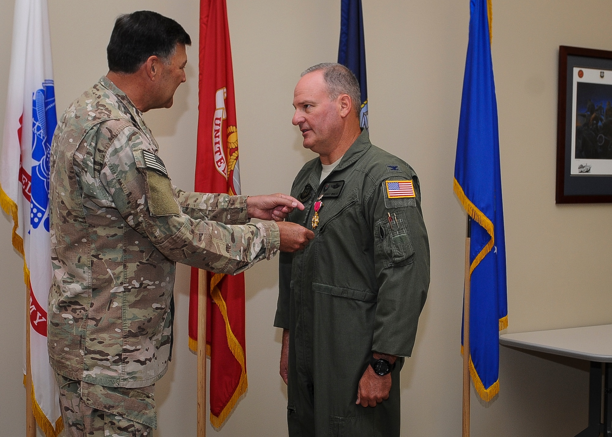 Lt. Gen. Brad Heithold, commander of Air Force Special Operations Command, presents the Legion of Merit medal to Col. Scott Wolfe, AFSOC safety director, at Hurlburt Field, Fla., April 20, 2016. The safety office won back-to-back Foulois awards during Wolfe's tenure, which recognizes the most exemplary flight safety record for all Air Force major commands.(U.S. Air Force photo by Senior Airman Meagan Schutter)