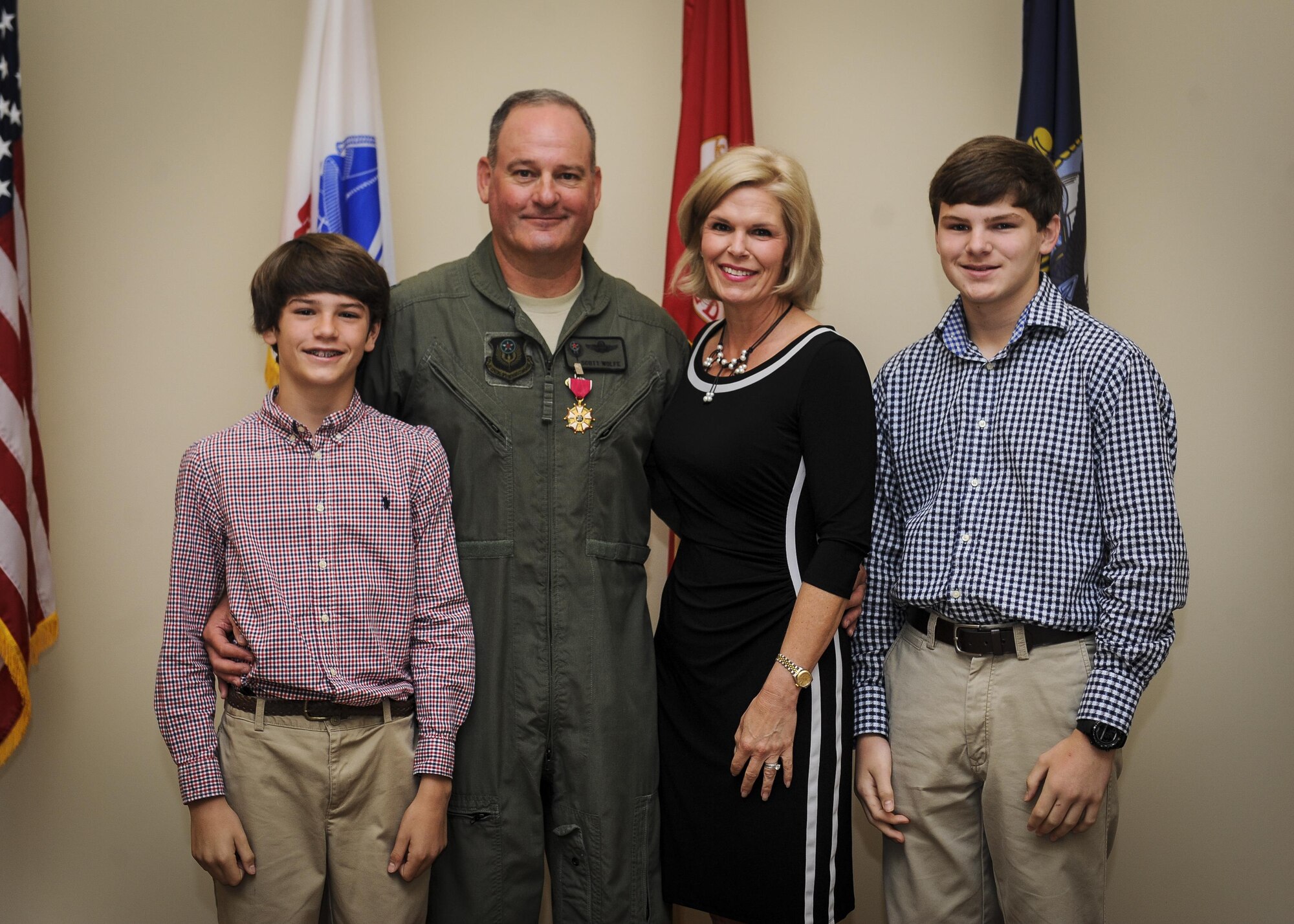 Col. Scott Wolfe, Air Force Special Operations Command safety director, poses for a photo with his family after retiring at Hurlburt Field, Fla., April 20, 2016. Wolfe accepted a contracting position at the 19th Special Operations Squadron. (U.S. Air Force photo by Senior Airman Meagan Schutter)