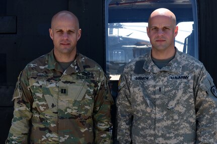 U.S. Army Capt. Jay Sirmon, an engineer officer assigned to the training site command, and his brother Warrant Officer 3 William Sirmon, a pilot assigned to the 1-111th General Support Aviation Battalion, South Carolina Army National Guard, pose after a flight taken to survey the recovery efforts in Columbia on April 5, 2016 following the flood that hit the area in Oct. 2015. Many bridges and roads remain closed six months later as recovery efforts are still underway. 