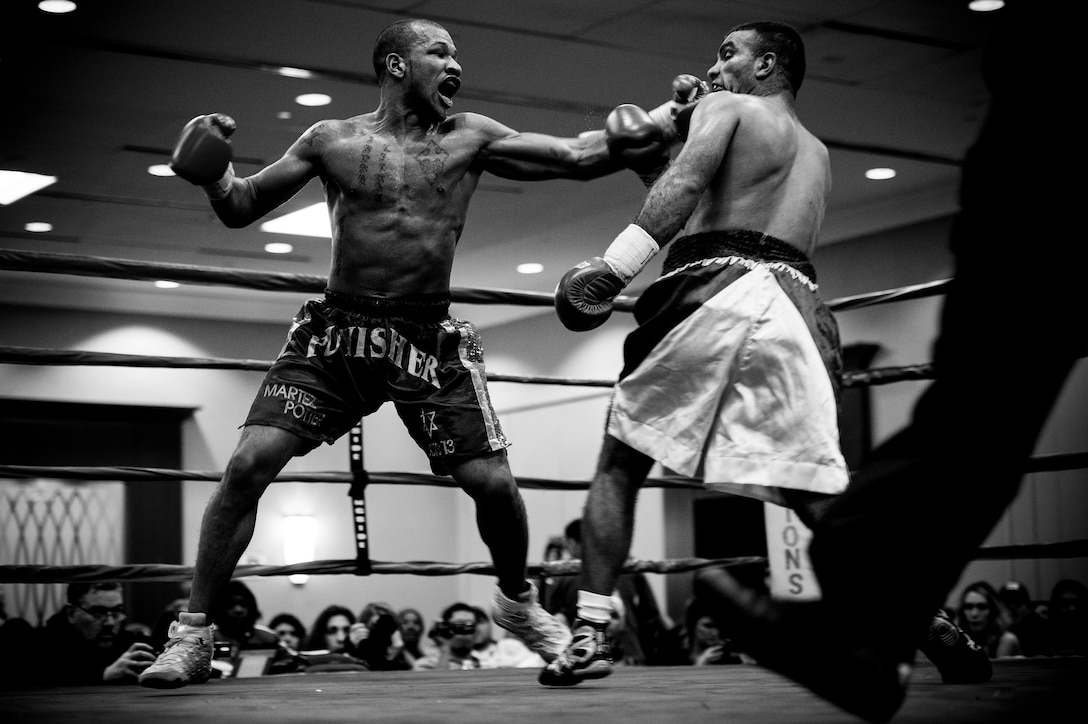 Sports Photography: Martez "The Punisher" Potter, of Syracuse unleashes a left hook against Ahmed Tuba, of Nazareth, Israel during their Super-Middle weight bout in Syracuse, N.Y., Feb. 28, 2015. Potter won the bout via unanimous decision, improving his record to 7-0. U.S. Air Force photo by Staff Sgt. Larry E. Jr. Reid