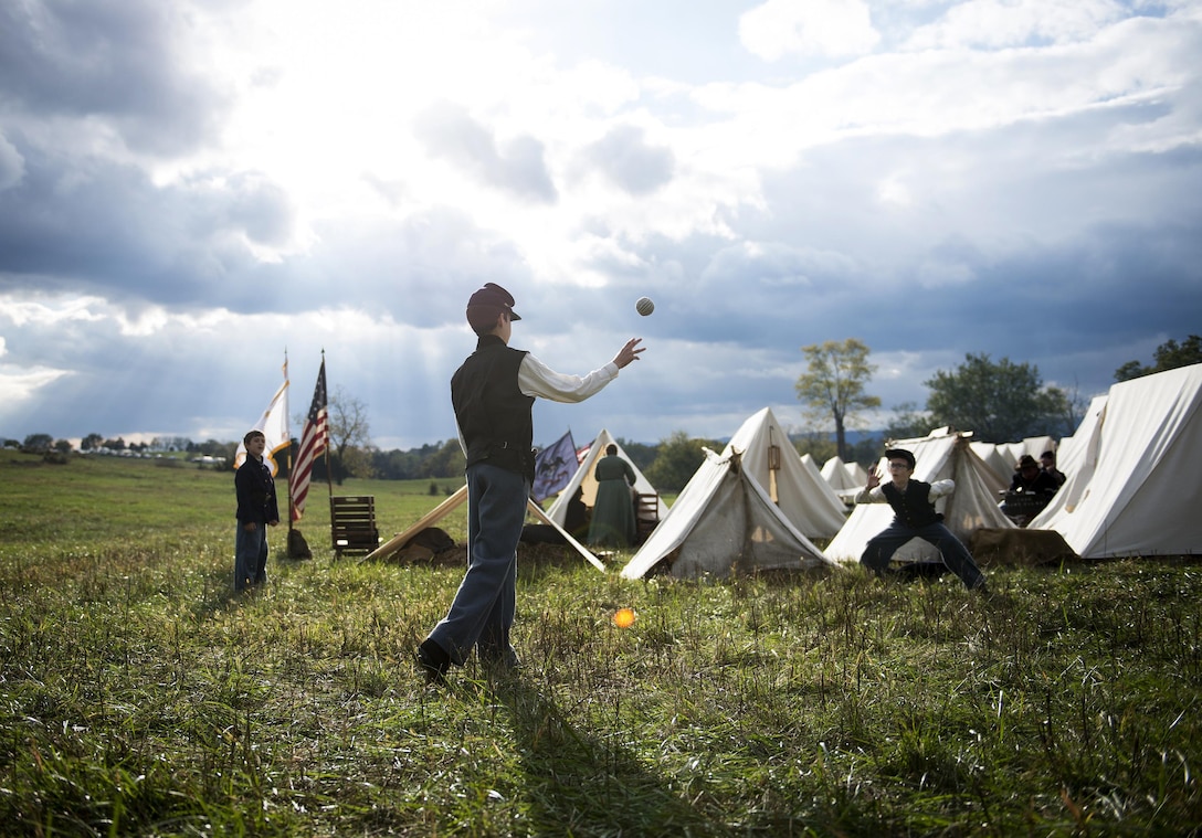 Sports Photography: Dean Badamo, middle, 9, along with his brothers Steve, 11, and Joseph, 6, play a game of toss after the first re-enactment battle at the battlefield of Cedar Creek in Virginia on Oct. 17, 2015. The three boys accompanied their father, Thomas Badamo, to the re-enactment for the 151st Anniversary of the battle. U.S. Air Force photo by Staff Sgt. Andrew Lee