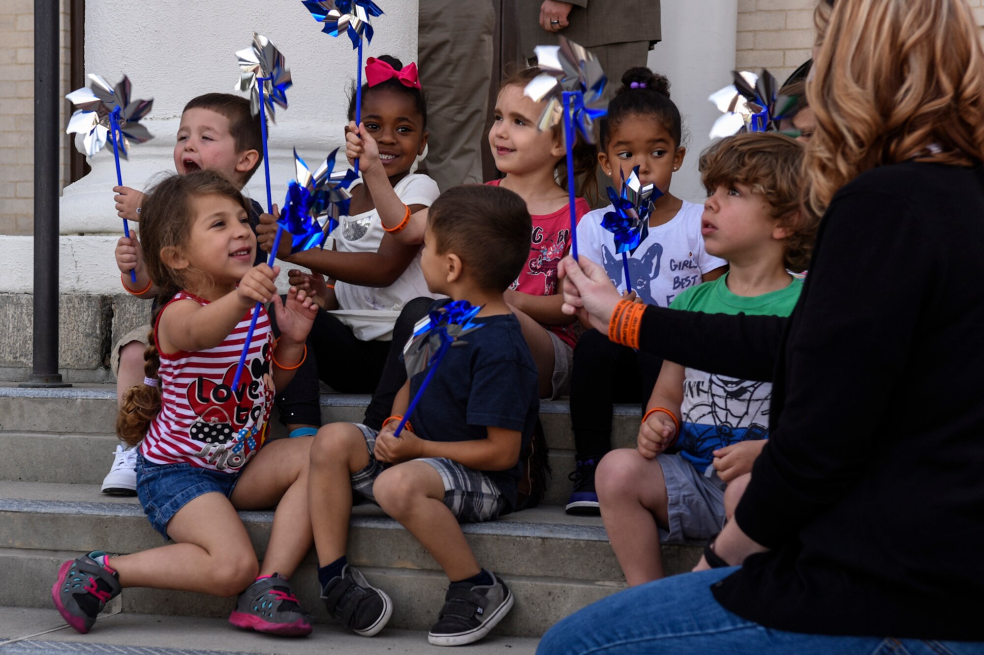 Team Seymour children gather on the steps of City Hall, April 19, 2016, in Goldsboro, North Carolina. During the Child Abuse Prevention Proclamation Ceremony the children held pinwheels; the symbol for child abuse and neglect prevention. (U.S. Air Force photo by Airman Shawna L. Keyes/Released)