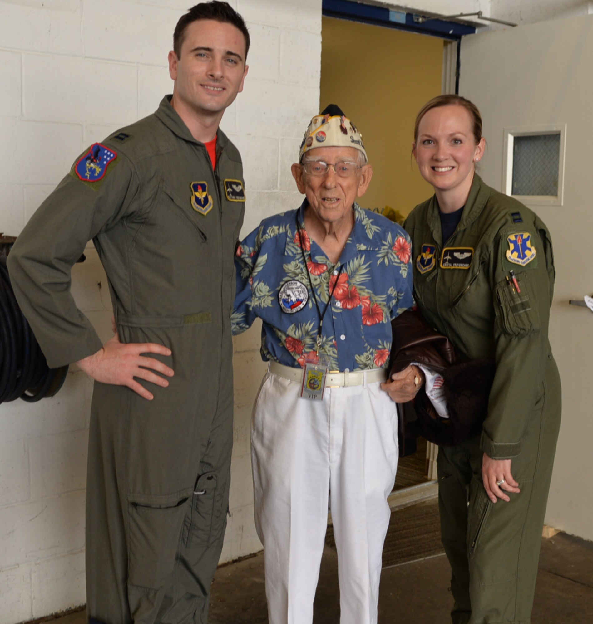 Captains Crystal and Matthew Provuncher, both combat systems officers and instructors assigned to Naval Air Station Pensacola with the 479th Flying Training Group 
pose for a photo with Navy veteran Jay Carraway before the NAS Pensacola Doolittle Raiders Association commemoration April 15, 2016. (U.S. Air Force photo by Randy Martin) 