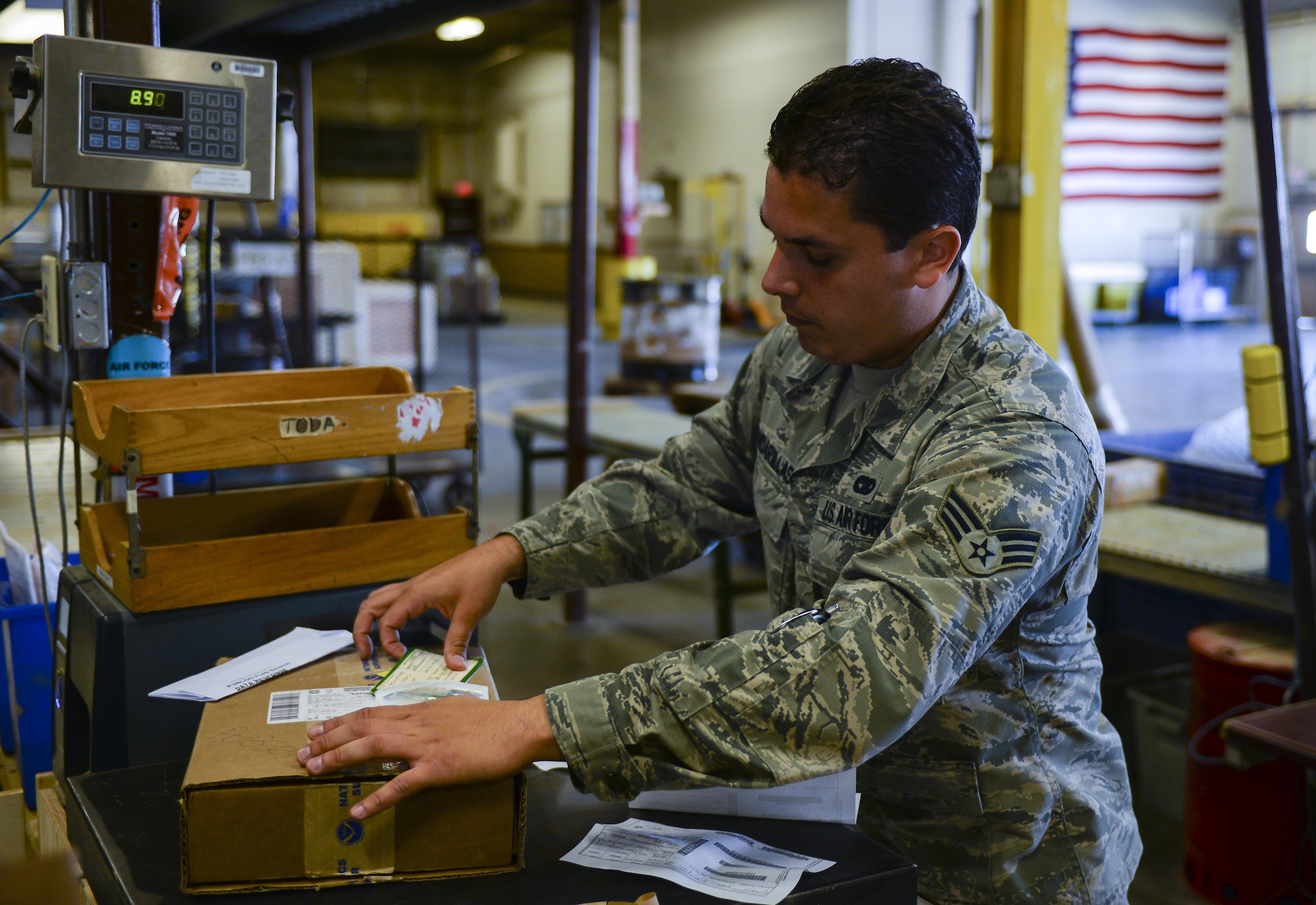 Senior Airman Thiago Gandarillas, 99th Logistics Readiness Squadron acting NCO in charge of planning and packaging, prepares a package for shipment at Nellis Air Force Base, Nev., on April 18, 2016. The 99th LRS Cargo Movement Section won the Air Force-Level Defense Packaging Excellence and Achievement Award for the first time for their accomplishments in 2015. (Air Force photo by Airman 1st Class Nathan Byrnes)