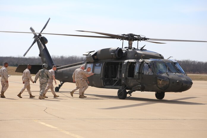 MajGen. Coglianese and the Marines board a Blackhawk for an aerial tour of Fort Leonard Wood.