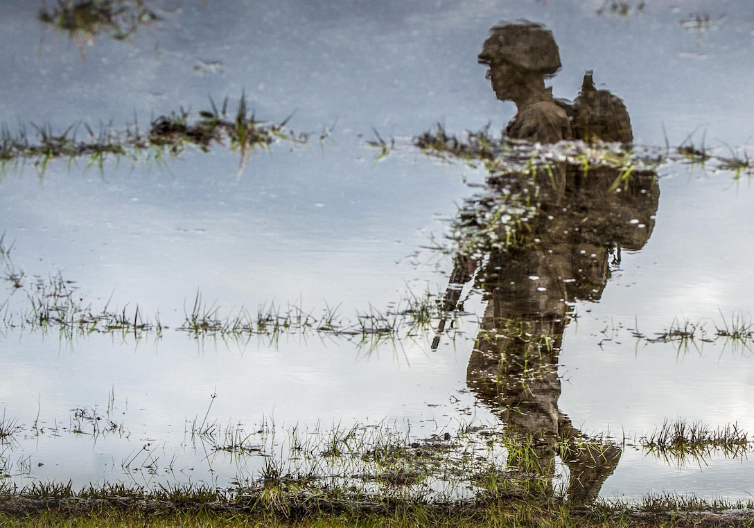 A Marine Corps recruit moves through a saturated area during tactical training at the Marine Corps Recruit Depot Parris Island, S.C., Dec. 3, 2015. Marine Corps photo by Staff Sgt. Marianique Santos