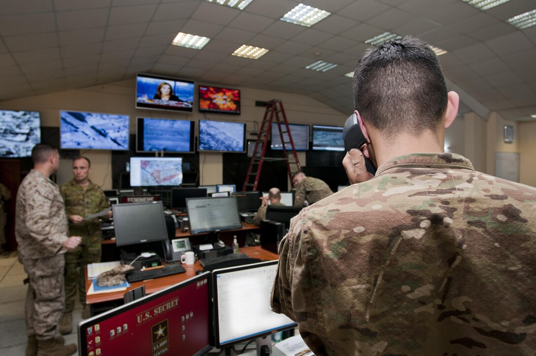 A coalition advisor takes a phone call from the Combined Joint Operations Center in Baghdad, Dec. 30, 2015. The CJOC brings coalition and Iraqi leaders under one roof to plan future operations for the Iraqi security forces, coordinate airstrikes, and provide command and control over Iraqi forces throughout Iraq’s Tigris and Euphrates River Valleys. Army photo by Staff Sgt. William Reinier 