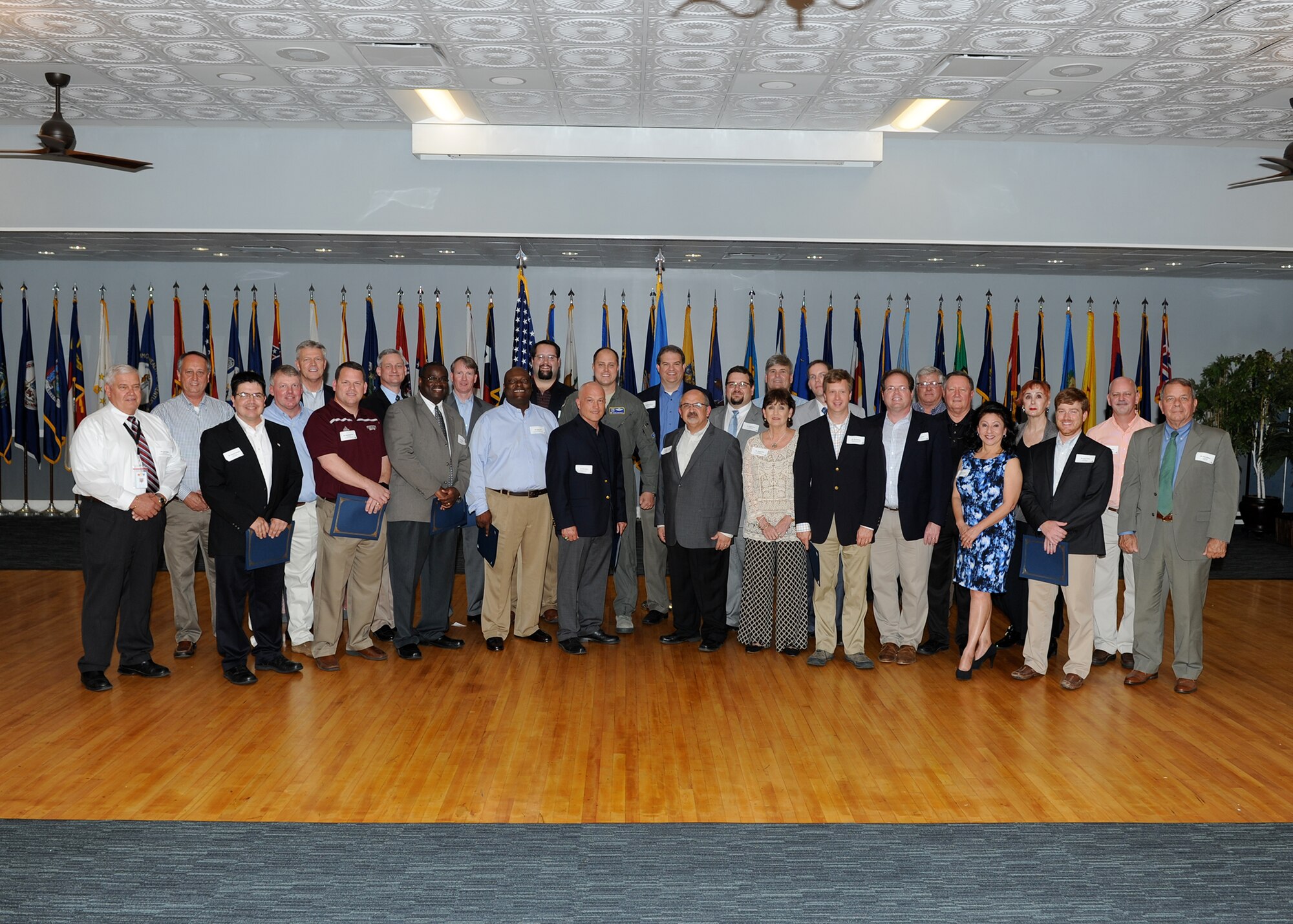 The newest 14th Flying Training Wing Honorary Commanders stand together after a reception April 19 at Columbus Air Force Base, Mississippi. The reception was hosted to induct the wing’s newest Honorary Commanders into the program, and to recognize the outgoing commanders. (U.S. Air Force photo/Elizabeth Owens)