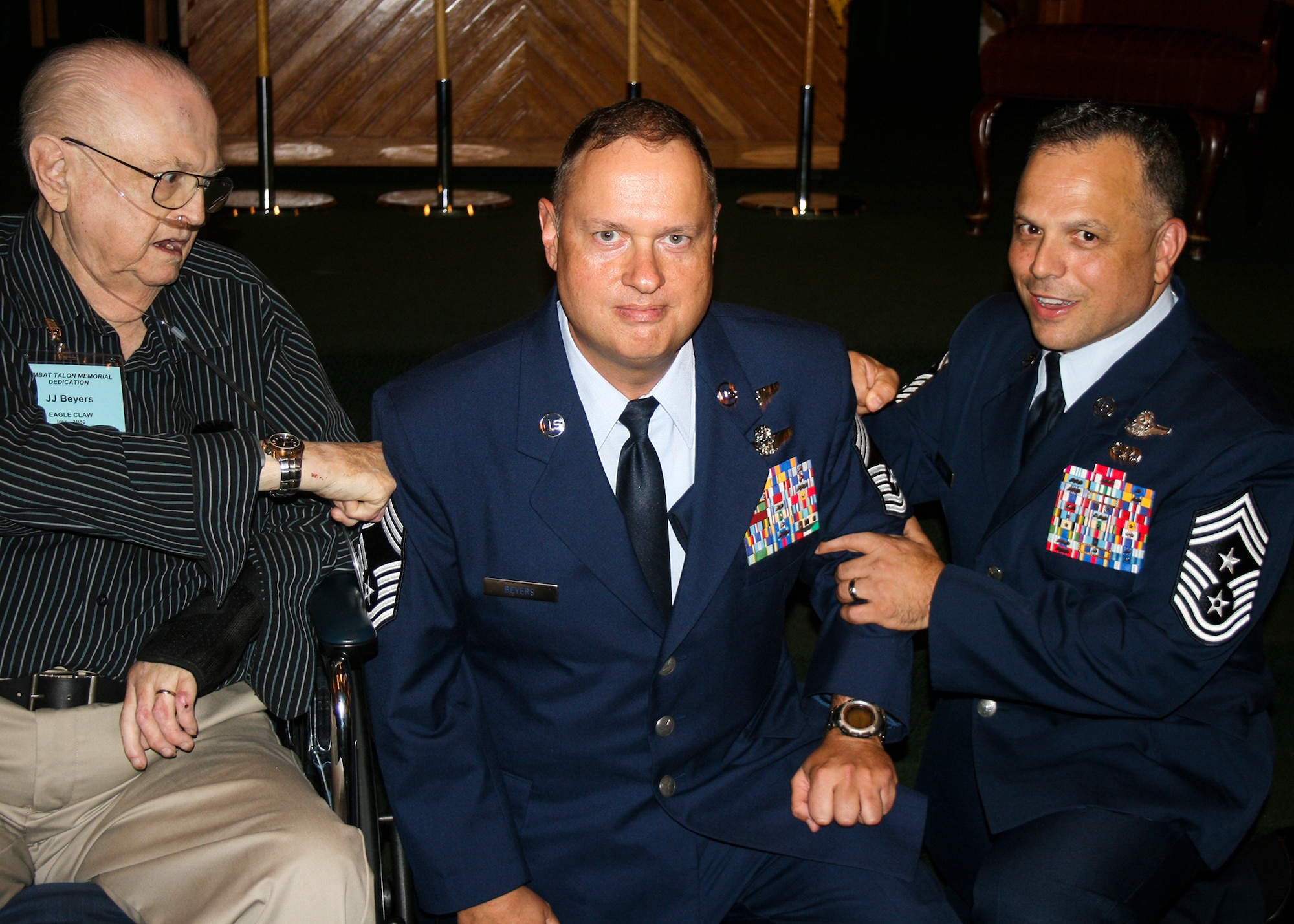 Chief Master Sgt. Raymond Beyers, 2nd Special Operations Squadron, had his new chevrons “tacked on” by his father, retired Staff Sgt. J.J. Beyers, and Chief Master Sgt Matthew Caruso, Air Force Special Operations Command Command Chief during a promotion ceremony at Hurlburt Field, Florida, in April 2015.  J.J. Beyers, an Operation Eagle Claw survivor who served 17 years in the Air Force, passed away nearly a month after the ceremony.  (Courtesy photo)     