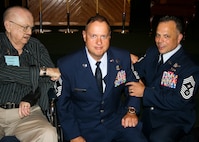 Chief Master Sgt. Raymond Beyers, 2nd Special Operations Squadron, had his new chevrons “tacked on” by his father, retired Staff Sgt. J.J. Beyers, and Chief Master Sgt Matthew Caruso, Air Force Special Operations Command Command Chief during a promotion ceremony at Hurlburt Field, Florida, in April 2015.  J.J. Beyers, an Operation Eagle Claw survivor who served 17 years in the Air Force, passed away nearly a month after the ceremony.  (Courtesy photo)     