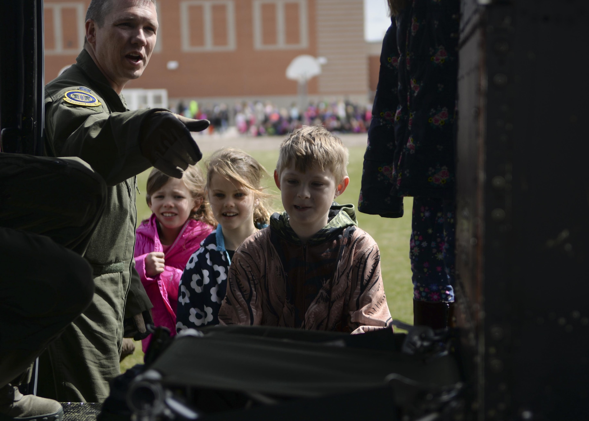 Capt. Barry Gordon, 37th Helicopter Squadron pilot, talks with children at Freedom Elementary School, Cheyenne, Wyo., about the UH-1N Bell Helicopter April 20, 2016. Several dozen children were able to view the helicopter and have their questions answered by the crew. (U.S. Air Force photo by Airman 1st Class Malcolm Mayfield)