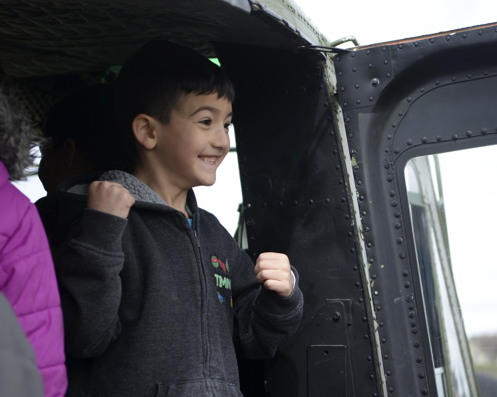 Daxton Roy, Freedom Elementary School student, looks out of a 37th Helicopter Squadron UH-1N Bell Helicopter April 20, 2016. The base and school faculty worked together in a joint effort to show the military children at the school how important they are. 
