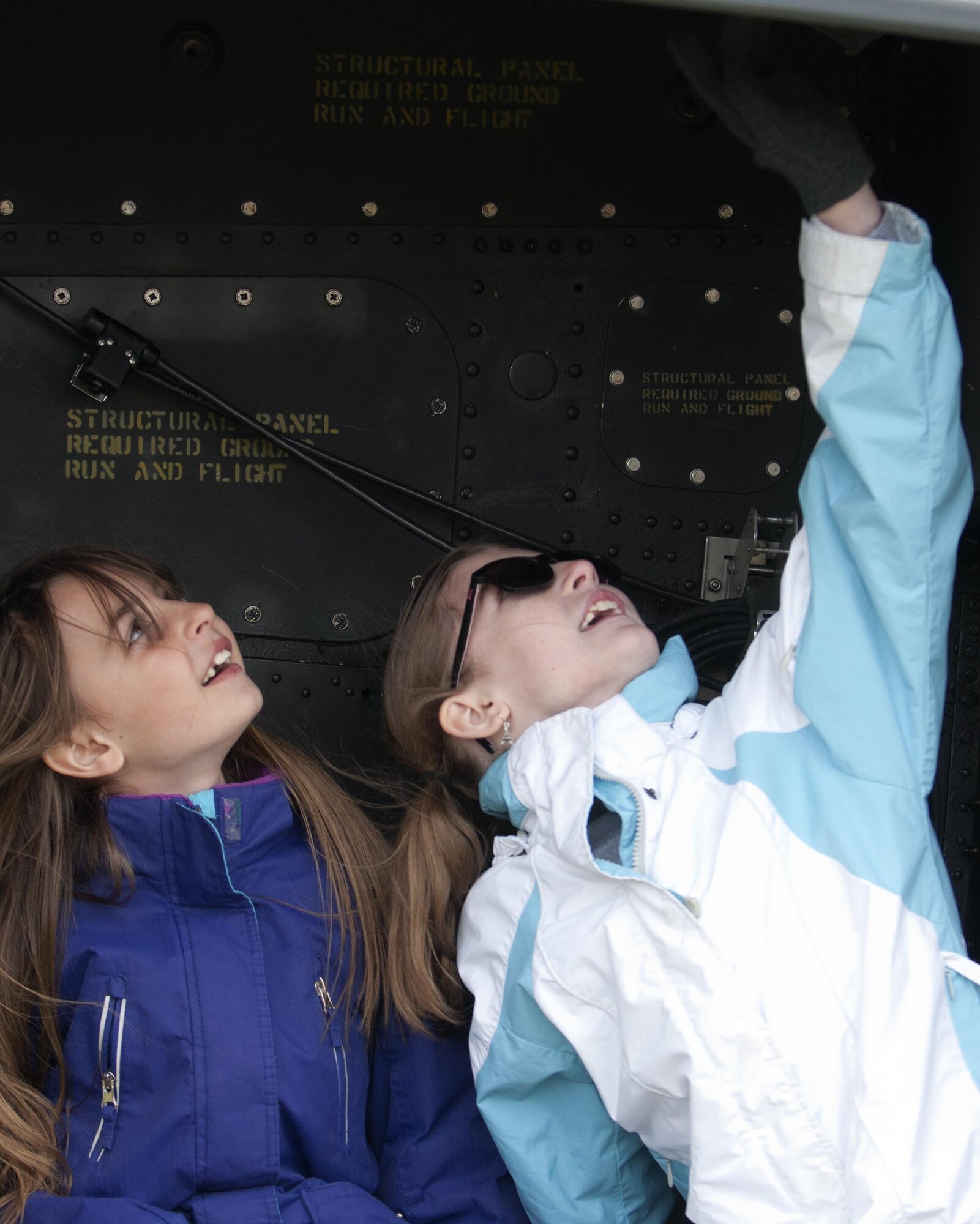 Alyssa Wagner, left, and Olivia Glover, Freedom Elementary School students, look at the inside of a UH-1N Bell Helicopter April 20, 2016 in Cheyenne, Wyo. Military children make up a large percentage of school’s student body. (U.S. Air Force photo by Airman 1st Class Malcolm Mayfield)