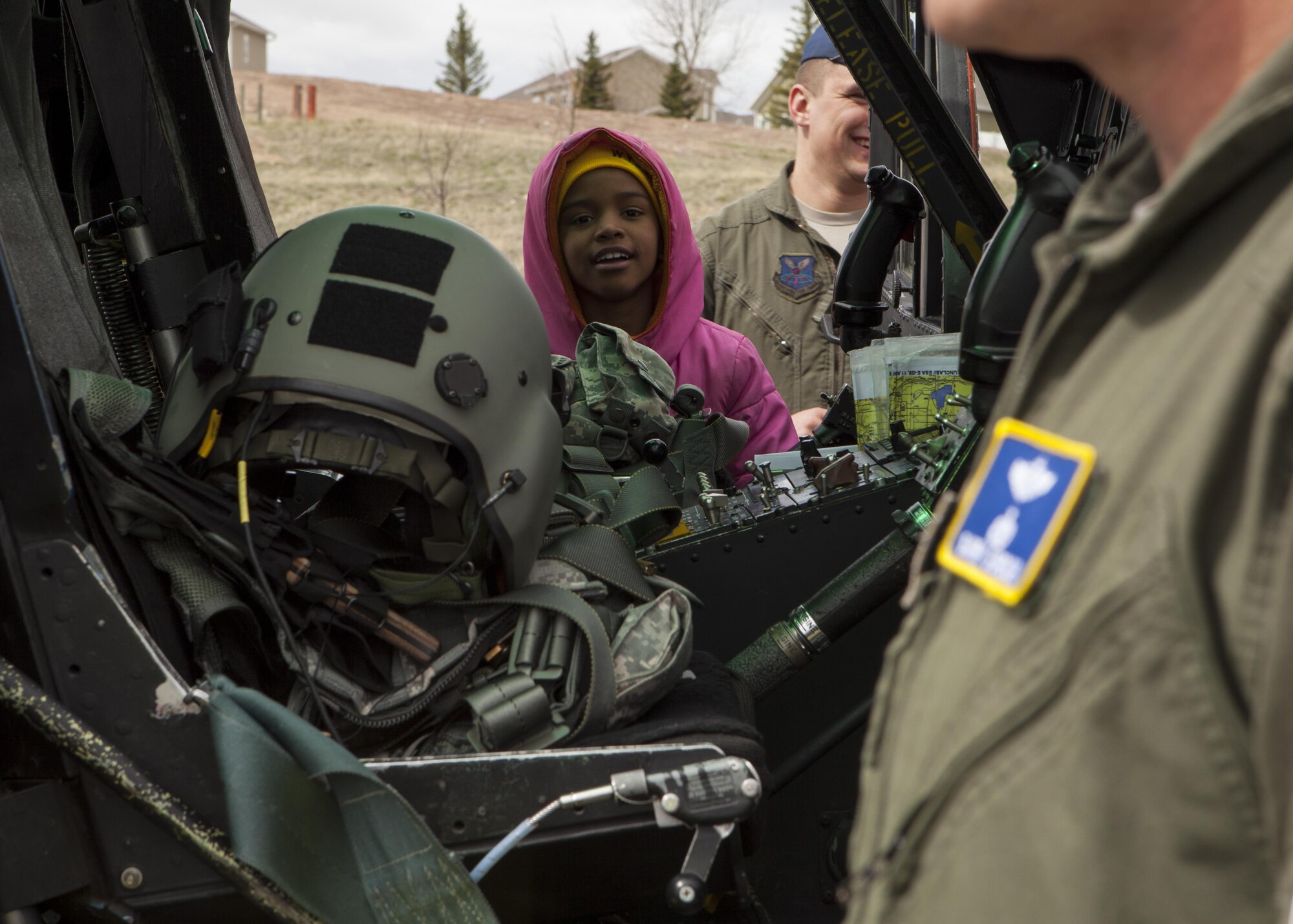 A student from Freedom Elementary School observes inside the cockpit of a 37th Helicopter Squadron UH-1N Huey Helicopter April 20, 2016, during a static display on school grounds. The majority of children attending Freedom Elemenatry have parents who are stationed at F.E. Warren Air Force Base, Wyo. (U.S. Air Force Photo by Lan Kim)
