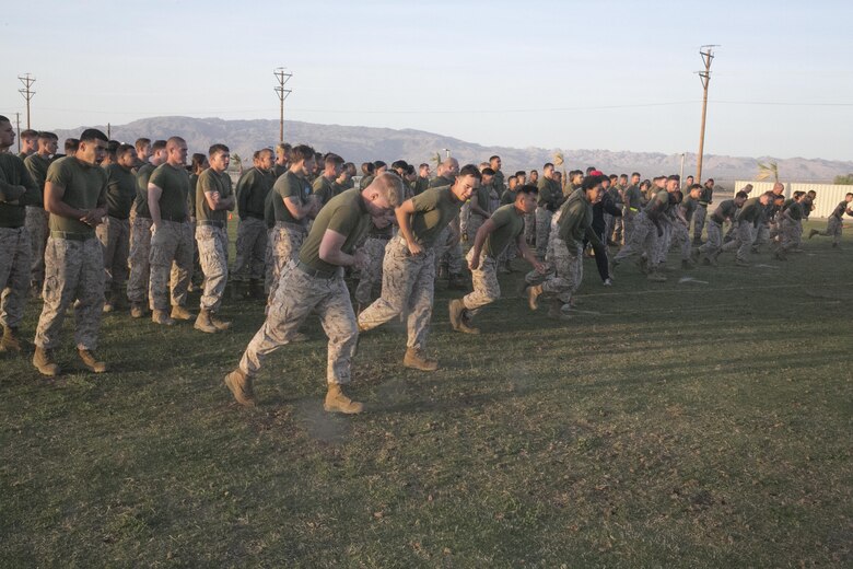 Marines with Headquarters Battalion begin their warm-ups during a High Intensity Tactical Training event held by Sgt. Maj. Avery Crespin, Headquarters Battalion Sergeant Major, and the HITT staff at Del Valle Field April 15, 2016. (Official Marine Corps photo by Cpl. Thomas Mudd/Released)