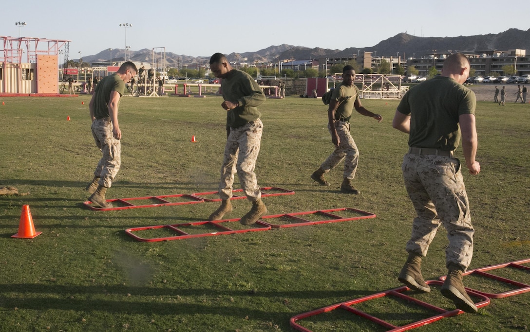 Marines with Headquarters Battalion practice agility drills during a High Intensity Tactical Training event held by Sgt. Maj. Avery Crespin, Headquarters Battalion Sergeant Major, and the HITT staff at Del Valle Field April 15, 2016. (Official Marine Corps photo by Cpl. Thomas Mudd/Released)