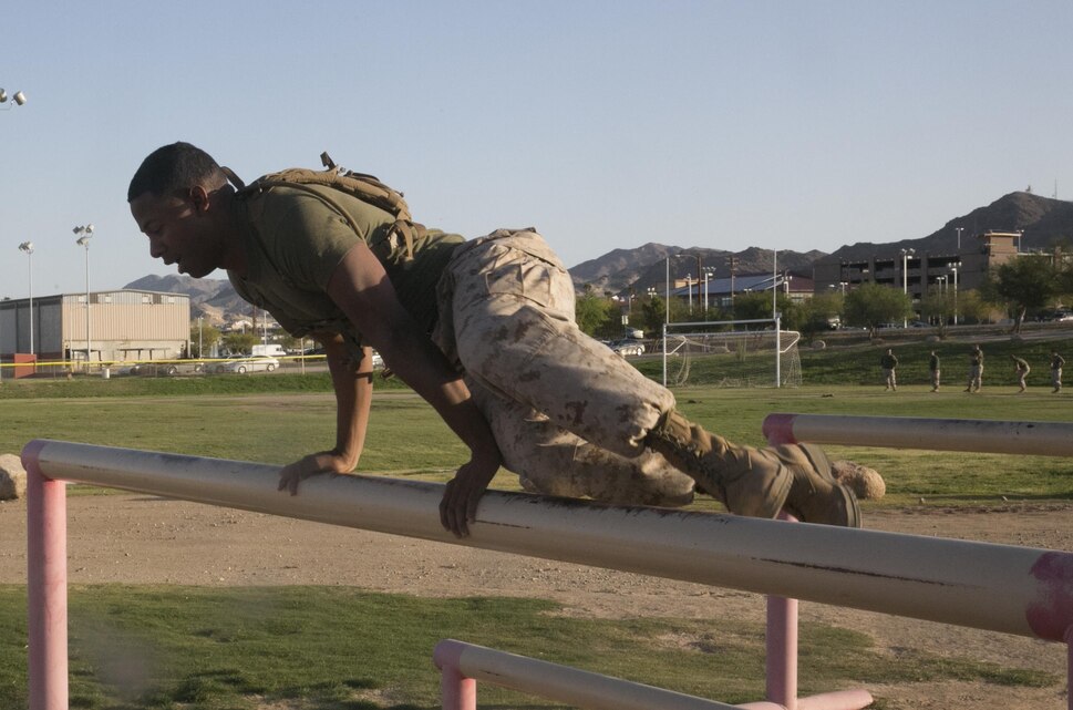 Cpl. Carlos Morris, staff driver, Headquarters Battalion, vaults over an obstacle during a High Intensity Tactical Training event held by Sgt. Maj. Avery Crespin, Headquarters Battalion Sergeant Major, and the HITT staff at Del Valle field April 15, 2016. (Official Marine Corps photo by Cpl. Thomas Mudd/Released)