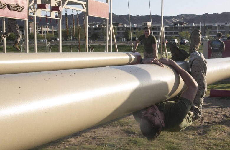 Pfc. Garrett Ellison, admin clerk, Installation Personnel Administration Center, performs an upside down crawl during a High Intensity Tactical Training event held by Sgt. Maj. Avery Crespin, Headquarters Battalion Sergeant Major, and the HITT staff at Del Valle Field April 15, 2016. (Official Marine Corps photo by Cpl. Thomas Mudd/Released)
